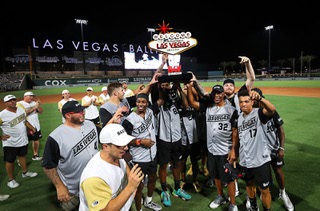 Team Marcus players hold up the trophy after beating Team Riley, 25-16, during the Battle 4 Vegas charity softball game at the Las Vegas Ballpark in Summerlin Saturday, July 24, 2021. Pro Football Hall of Famer Marcus Allen is #32. The game featured Las Vegas Raiders players against members of the Vegas Golden Knights.