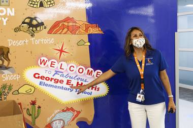 Principal Margarita Harris points to an altered “Welcome to Fabulous Las Vegas” sign on a mural at the newly rebuilt George E. Harris Elementary School Monday, July 26, 2021. 