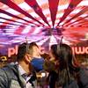 A couple wearing face masks kisses as they celebrate New Year's Eve along the Las Vegas Strip Thursday, Dec 31, 2020, in Las Vegas. 