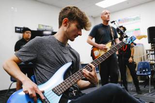 Aaron Carlson, 17, plays bass guitar during a Rock Academy of the Performing Arts rehearsal at Delta Academy in North Las Vegas Thursday, July 29, 2021.