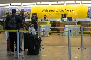 People line up for rental cars at the McCarran Rent-A-Car Center Friday, July 30, 2021.