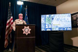 A screen shows the path of a carjacking pursuit while Las Vegas Metro Police Undersheriff Christopher Darcy speaks during a press conference to discuss details of the event, which resulted in the death of an officer and the suspect, Monday, Aug. 2, 2021. Nevada Highway Trooper Micah May, 46, died Thursday after he was struck by a carjacking suspect during a pursuit on Interstate 15 on July 27.