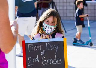 Charlie Gonzalez, 7 years old, holds up a sign during the first day of school at the new Hannah Marie Brown Elementary School in Henderson, NV Monday, Aug. 9, 2021.