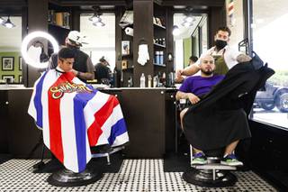 Barber Foster Palo, left, works on Luis Sotos hair, left, while Alejandro Perez, barber and owner of Faded Talk Babershop, right, finishes working on Donovan Cabana, right, at Faded Talk Thursday, Aug. 5, 2021.