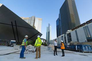 Developer Brett Torino, second from right, stands at the construction site for Project 63, an office and retail space, at City Center Thursday, Aug. 12, 2021.