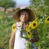 Diane E. Greene holds sunflowers to make a bouquet for a customer at Herbs by Diane garden farm in Boulder City Tuesday, Aug. 17, 2021.
