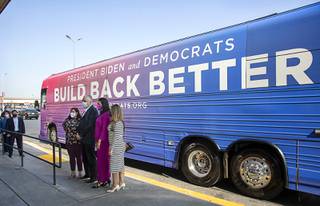 Speakers pose in front to the Build Back Better bus following a news conference at Eastside Cutters barber shop at Eastern Avenue and Bonanza Road Tuesday, Aug. 24, 2021. From left are: Erica Mosca, executive director of Leaders in Training, Nevada Governor Steve Sisolak, Las Vegas City Councilwoman Olivia Diaz, and Cecia Alvarado, Nevada State Director for Mi Familia Vota. The event was part of the Democratic National Committees Build Back Better bus tour which made a stop at the barber shop.
