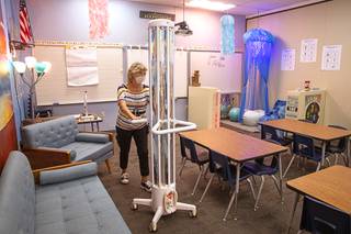 Lisa Davis, a support staff trainer, moves an R-Zero machine out of a room at Kesterson Elementary School in Henderson Wednesday, Aug. 25, 2021. The Clark County School District will implement 372 R-Zero systems - one for every campus in the district.