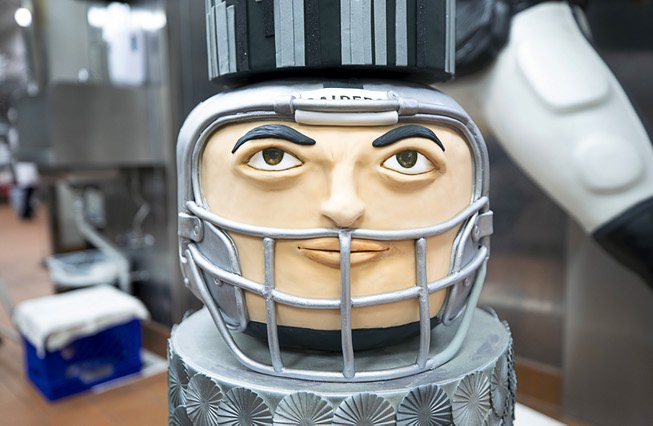 A details is shown on a Las Vegas Raiders-themed cake ...