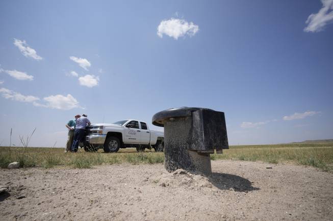 In this Monday, July 26, 2021, photograph, a well head is shown on the Terry Bison Ranch as Cole Gustafson, a water resource administrator for the Greeley, Colo., Water Department, works near his pickup truck. Population growth continues unabated in the South and West, even as temperatures rise and droughts become more common. That in turn has set off a scramble of growing intensity in places like Greeley to find water for the current population, let alone those expected to arrive in coming years.

