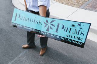 Neighborhood Organizer Dave Cornoyer holds a new street sign topper in the Paradise Palms historic neighborhood Wednesday, Sept. 1, 2021.