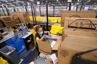 Marisol C. LaRue works at a packing station during a tour of an Amazon warehouse in Las Vegas Thursday, Sept. 1, 2021.