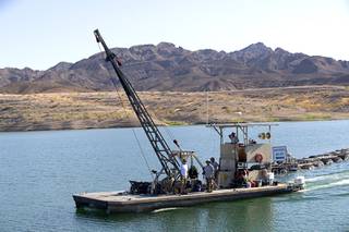 A dock crew prepares to start work on moving the marina farther out into the lake due to falling water levels at the Callville Bay Marina in the Lake Mead National Recreation Area Tuesday, Sept. 14, 2021.