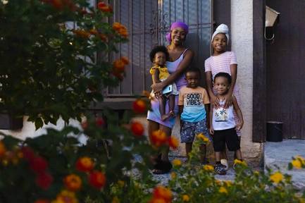 Desiree Robinson is shown Wednesday, Sept. 15, 2021, at her home in North Las Vegas with her children, from left, Nova, 1; Messiyah, 3; Malachi, 2; and Nalani, 9. Robinson’s husband, Michael Myers, was one of three people shot to death Sept. 1 in a string of apparently random shootings, North Las Vegas Police said. Myers’ death, Robinson said, has left the family scrambling, but she is grateful for the support the family has received from the community since the tragedy.