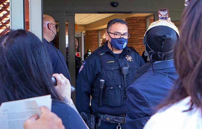 Police keeps people from reentering the building after they were removed from a commission meeting at the Clark County Government Center Tuesday, Sept. 21, 2021.