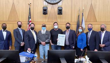 Clark County commissioners flank John Isaacson (fourth from left), Othram Labs founder David Mittelman and Henderson philanthropist Justin Woo, Sept. 21, 2021. The commission issued a proclamation to honor Woo, who funded DNA testing that helped Metro Police solve the slaying of 14-year-old Stephanie Isaacson, who was killed three decades ago. 