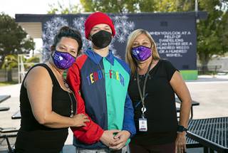 Landynn Meyers, center, poses with Principal Barbara Collins, left, and Rene Rehmel, a drug and alcohol counselor, at Mission High School Thursday, Sept. 23, 2021. Meyers, a former addict and graduate of Mission High, is now learning how to become a peer recovery specialist.