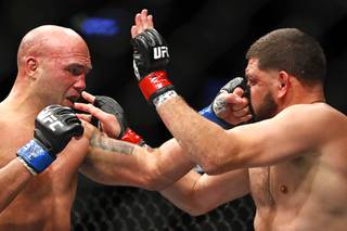 Robbie Lawler, left, lands a punch on Nick Diaz in a middleweight bout during UFC 266 at T-Mobile Arena Saturday, Sept. 25, 2021. Lawler beat Diaz with a third-round TKO.