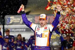 NASCAR Cup Series driver Denny Hamlin (11) celebrates in victory lane after winning a NASCAR Cup Series auto race at the Las Vegas Motor Speedway Sunday, Sept. 26, 2021, in Las Vegas.