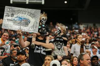 Raiders fans cheer as Vegas begins the second half of their game against Miami at Allegiant Stadium Sunday, Sept. 26, 2021.  The Raiders beat the Dolphins 31 to 28 in overtime.