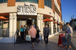 People head into Sticks Tavern during a tour of Water Street in downtown Henderson Wednesday, Sept. 29, 2021.