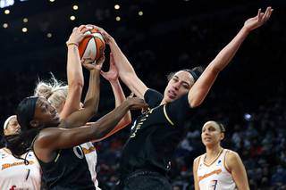 Las Vegas Aces guard Jackie Young (0) and Las Vegas Aces forward Dearica Hamby (5) fight for a rebound with Phoenix Mercury guard Sophie Cunningham (9) during the second half of Game 2 in the semifinals of the WNBA playoffs at the Michelob Ultra Arena Thursday, Sept. 30, 2021.