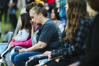 A person wipes away tears during a fourth annual Oct. 1 sunrise remembrance ceremony at the Clark County Government Center Amphitheater Friday, Oct. 1, 2021.