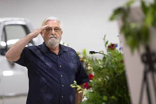 Bill Rose salutes a photo of his best friend during a memorial service for ex-Harry Reid aide and retired Nevada Army National Guard Maj. Gen. Robert T. Herbert at the Nevada Army National Guard Las Vegas Readiness Center Saturday, Oct. 2, 2021. Herbert died Friday at age 64.