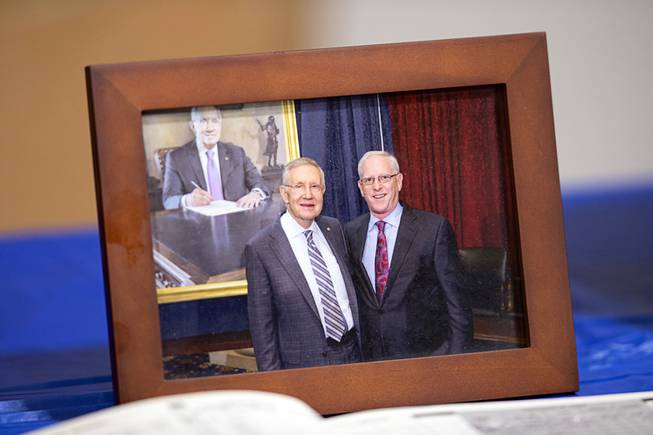 A photo, showing retired Nevada Army National Guard Maj. Gen. Robert T. Herbert, right, with then Senate Majority Leader Harry Reid, is displayed during a memorial service for Herbert at the Nevada Army National Guard Las Vegas Readiness Center Saturday, Oct. 2, 2021. Herbert served as the Senior Policy Advisor and Director of Appropriations for Senator Harry Reid in Washington, D.C. from 2001 to 2017.