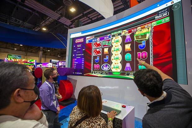 Attendees line up to play in a video slot tournament during the Global Gaming Expo (G2E) at the Sands Expo Center Tuesday, Oct. 5, 2021.