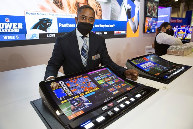 Darnell Johnson, senior director of protect management at IGT, stands behind an IGT Peak BarTop machine during the Global Gaming Expo (G2E) at the Sands Expo Center Tuesday, Oct. 5, 2021. The machine can play the traditional slot machine and video poker games but also incorporates sports betting and live sports viewing.
