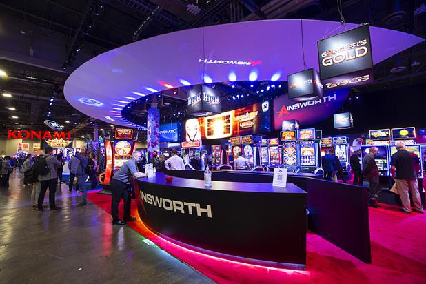 Attendees look over video slot machines at the Ainsworth Game Technology booth during the Global Gaming Expo (G2E) at the Sands Expo Center Tuesday, Oct. 5, 2021.