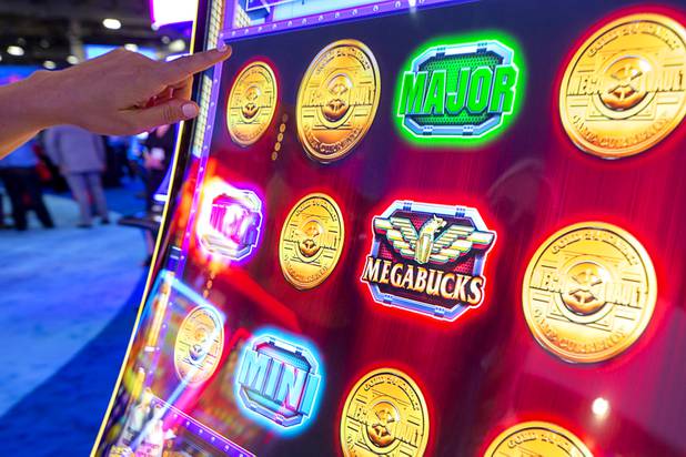 A woman plays a Megabucks bonus game at the IGT booth  during the Global Gaming Expo (G2E) at the Sands Expo Center Tuesday, Oct. 5, 2021.
