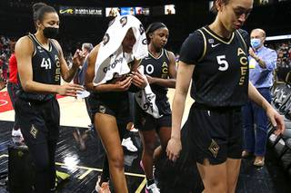 Las Vegas Aces forward A'ja Wilson, with towel, leaves the court with teammates after the Aces were defeated by the Phoenix Mercury in Game 5 of the semifinals of the WNBA playoffs at the Michelob ULTRA Arena Friday, Oct. 8, 2021. The Mercury defeated the Aces 87-84.