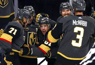Vegas Golden Knights center Jonathan Marchessault, center, celebrates with teammates after scoring during the first period of an NHL hockey game against the Seattle Kraken at T-Mobile Arena Tuesday, Oct. 12, 2021.