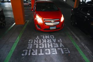 Paul Bordenkircher drives his Chevy Spark electric vehicle into a parking spot designated for electric vehicles only at Downtown Summerlin Tuesday, Oct. 12, 2021.