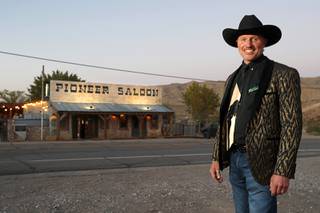 Owner Stephen Staats, also known as Old Man Liver, poses outside the Pioneer Saloon in Goodspings, Nev. Wednesday, Oct. 13, 2021.
