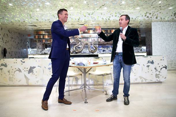 Anthony Carano, left, president/COO of Caesars Entertainment, and Ross Mollison, founder and Impresario Extraordinaire of Spiegelworld, toast with Champagne at Caesars Palace in Las Vegas Thursday, Oct. 14, 2021. Caesars Entertainment and Spiegelworld announced a nearly $75 million deal to create new live theater projects at casinos in Las Vegas, Atlantic City and New Orleans.