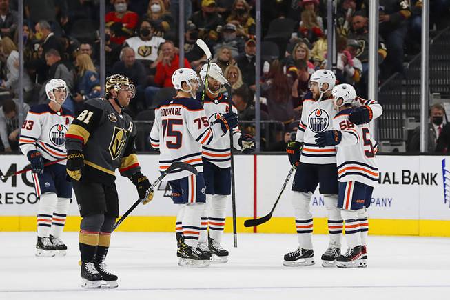 Vegas Golden Knights center Jonathan Marchessault (81) skates by as the Edmonton Oilers celebrate an empty net goal in the third period of an NHL hockey game Friday, Oct. 22, 2021, in Las Vegas.