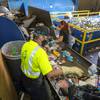 Workers Rigoberto Nieto-Gutierrez, left, and Angelica Aguilar fish out plastic bottles, cans and other recyclables from trash at the Caesars Palace recycling dock Tuesday, Oct. 26, 2021.