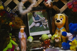A portrait of Tina Tintor and her dog Max is displayed at the site of a vigil Friday, Nov. 5, 2021. Tintor and Max were killed in a fatal car crash allegedly caused by former Raiders wide receiver Henry Ruggs III.