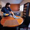 Brooke Cullum, a service professional with MaidPro Henderson, cleans a dining room in a home. 
