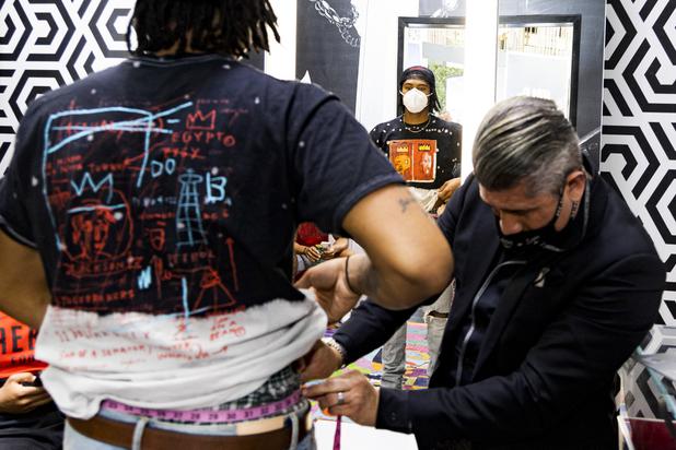 Ricci Lopez, Maceoos Retail and Creative Director, measures UNLV football player Noah Beans waist during a suit fitting at Aria Hotel & Casino Thursday, Nov. 11, 2021. Through a partnership with Blueprint sports, former UNLV kicker Michael Chudd is sponsoring a program (now possible under the new NCAA NIL rules) that will give each graduating member of the UNLV football team a custom-made suit from Maceeo in exchange for social media sharing.