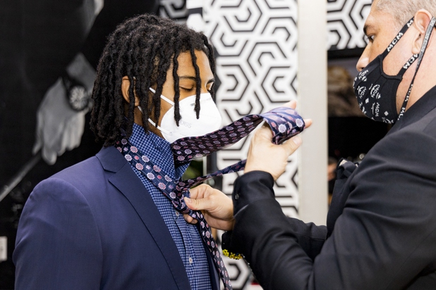 Ricci Lopez, Maceoos Retail and Creative Director, ties UNLV football player Noah Beans tie during a suit fitting at Aria Hotel & Casino Thursday, Nov. 11, 2021. Through a partnership with Blueprint sports, former UNLV kicker Michael Chudd is sponsoring a program (now possible under the new NCAA NIL rules) that will give each graduating member of the UNLV football team a custom-made suit from Maceeo in exchange for social media sharing.