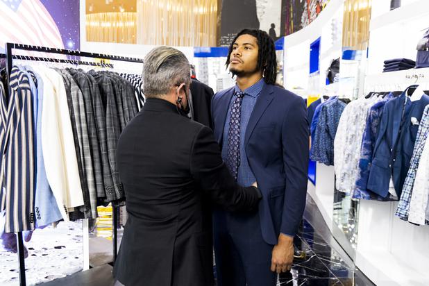 Ricci Lopez, Maceoos Retail and Creative Director, makes adjustments to UNLV football player Noah Beans pants during a suit fitting at Aria Hotel & Casino Thursday, Nov. 11, 2021. Through a partnership with Blueprint sports, former UNLV kicker Michael Chudd is sponsoring a program (now possible under the new NCAA NIL rules) that will give each graduating member of the UNLV football team a custom-made suit from Maceeo in exchange for social media sharing.