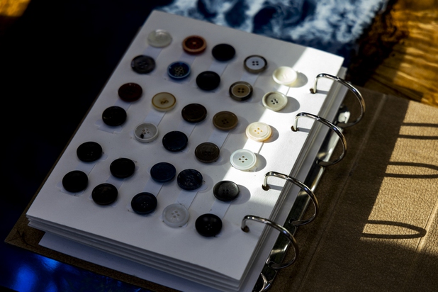 A button sample book lays on the coffee table of a VIP room at Maceoo inside Aria Hotel & Casino, Thursday, Nov. 11, 2021. Through a partnership with Blueprint sports, former UNLV kicker Michael Chudd is sponsoring a program (now possible under the new NCAA NIL rules) that will give each graduating member of the UNLV football team a custom-made suit from Maceeo in exchange for social media sharing.