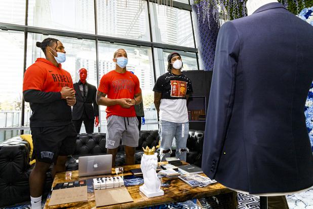 UNLV football players Farrell Hester, left, Tre Caine, center, and Noah Bean, right, tour the VIP room at Maceoo during a suit fitting at Aria Hotel & Casino Thursday, Nov. 11, 2021. Through a partnership with Blueprint sports, former UNLV kicker Michael Chudd is sponsoring a program (now possible under the new NCAA NIL rules) that will give each graduating member of the UNLV football team a custom-made suit from Maceeo in exchange for social media sharing.