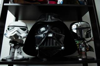 Various custom and collectable helmets and figures from Star Wars are seen on display in Steve Johnston's collection at his home, Tuesday Nov. 9, 2021. Johnston is a local collector, owner of Rogue Toys and an expert on antique and vintage toys who frequently appears on History Channel's Pawn Stars.