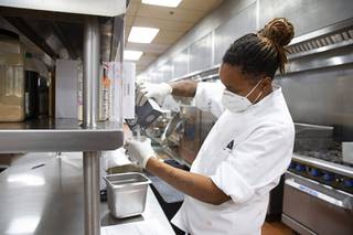 Sous chef Ashley Frazier measures spices for Lieds Meatloaf Lunch at Catholic Charities of Southern Nevada Wednesday, Nov. 17, 2021.  STEVE MARCUS