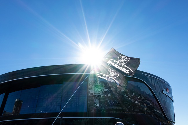 Raider fans raise the team flag outside Allegiant Stadium as the Raiders prepare to take on the Cincinnati Bengals Sunday Nov. 21, 2021.